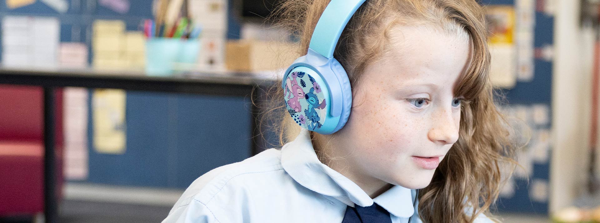 OLN Lawson student using a school laptop. She is also wearing headphones.