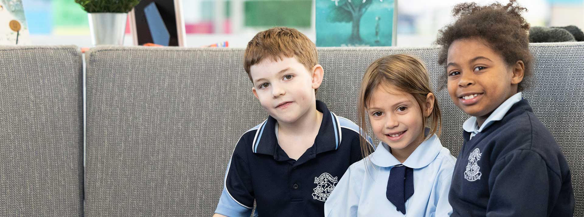 Three Our Lady of the Nativity Lawson Primary students sitting outdoors