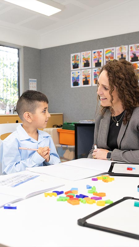 OLN Lawson teacher assisting two students