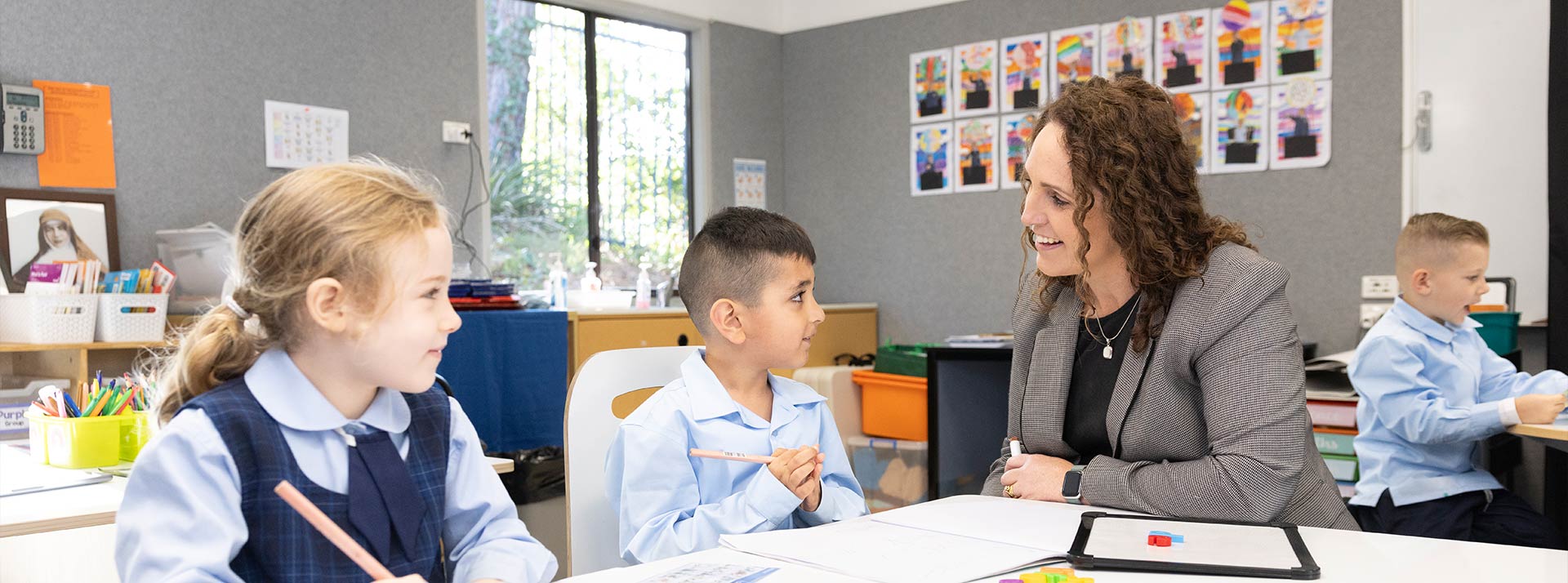 OLN Lawson teacher assisting two students