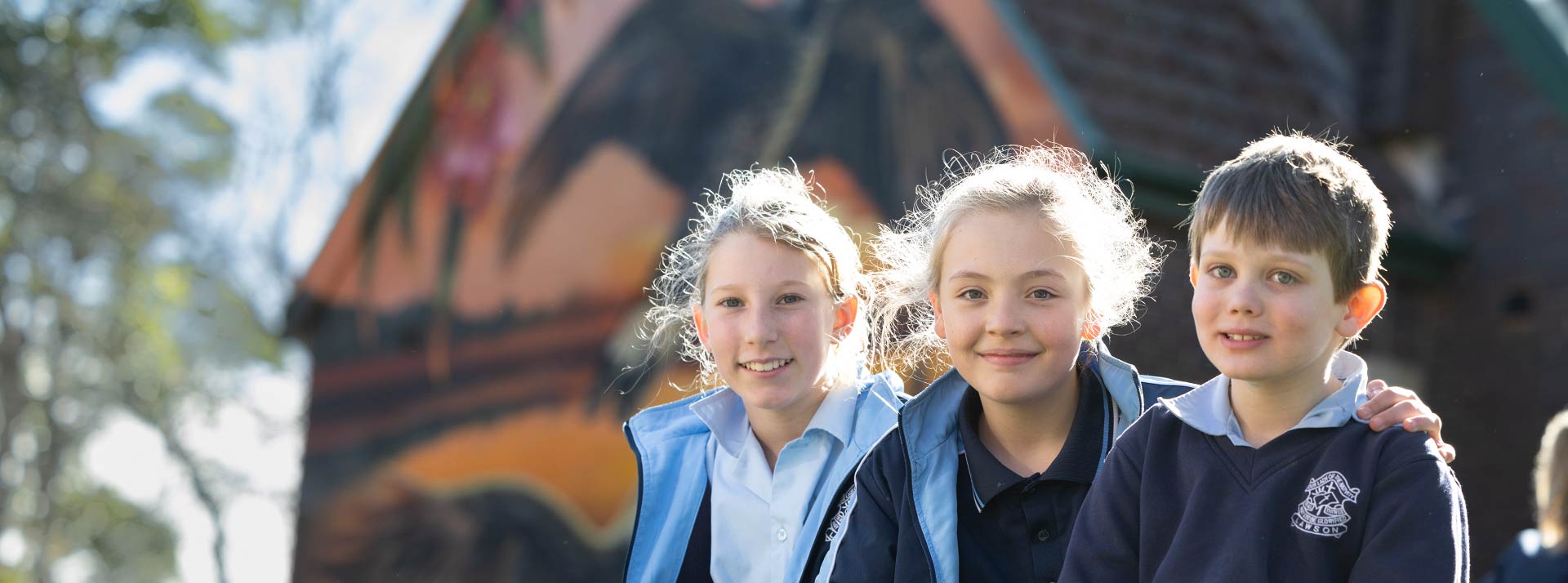 Three OLN Lawson students sitting outdoors