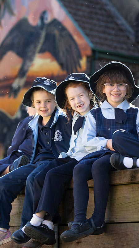 Three smiling Our Lady of the Nativity Primary Lawson students