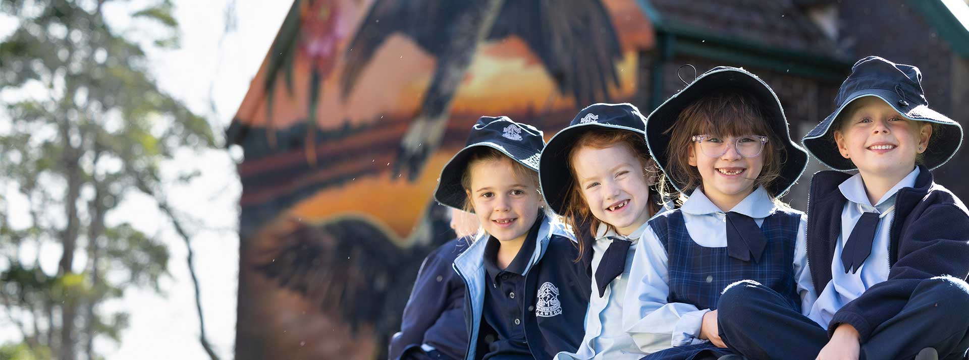 Four smiling Our Lady of the Nativity Primary Lawson students