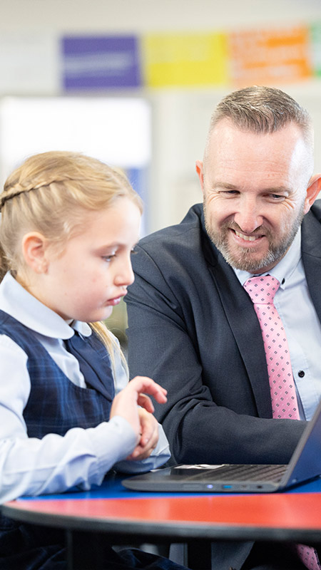 Matthew Bond, Principal of Our Lady of the Nativity Primary Lawson, assisting students in class