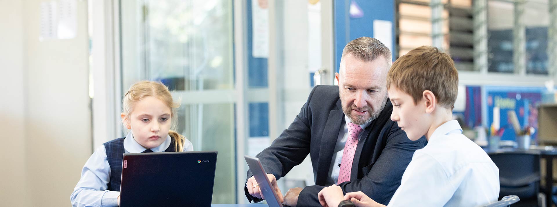 Matthew Bond, Principal of Our Lady of the Nativity Primary Lawson, assisting students in class
