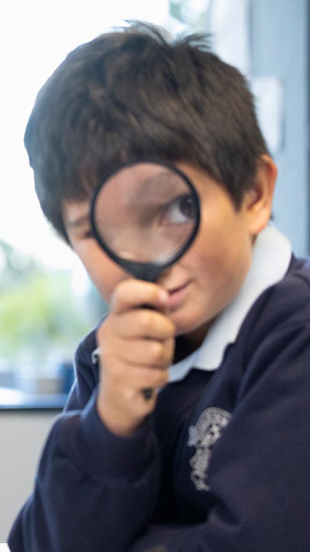 OLN Lawson students looking through a magnifying glass