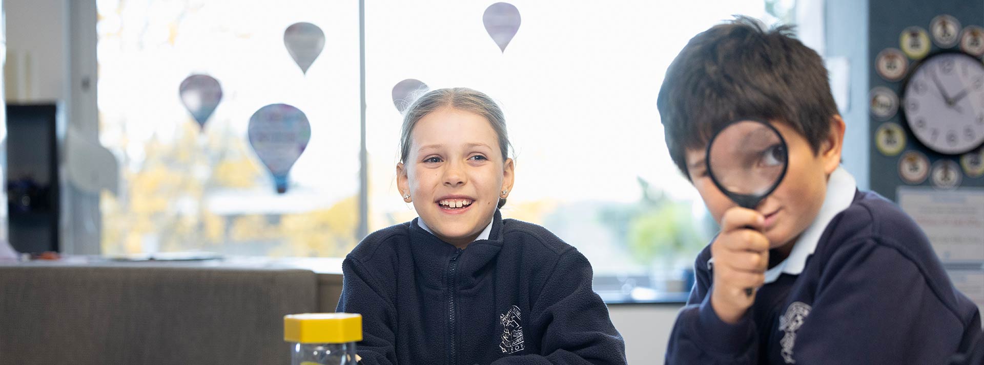 OLN Lawson students looking through a magnifying glass