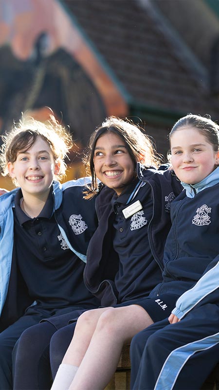 Four OLN Lawson students sitting out the front of the church