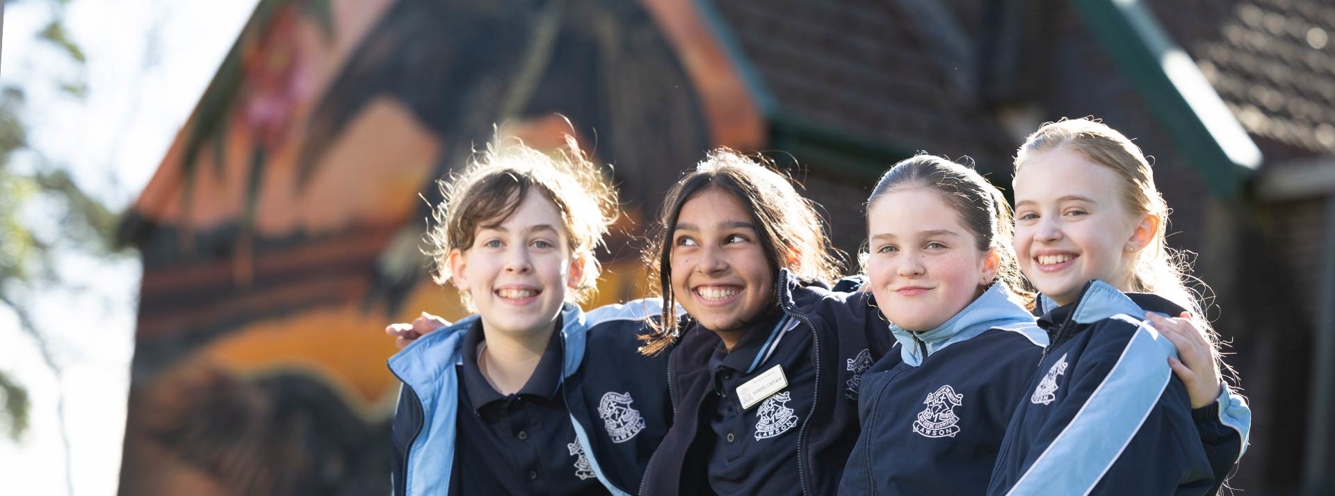 Four OLN Lawson students sitting out the front of the church