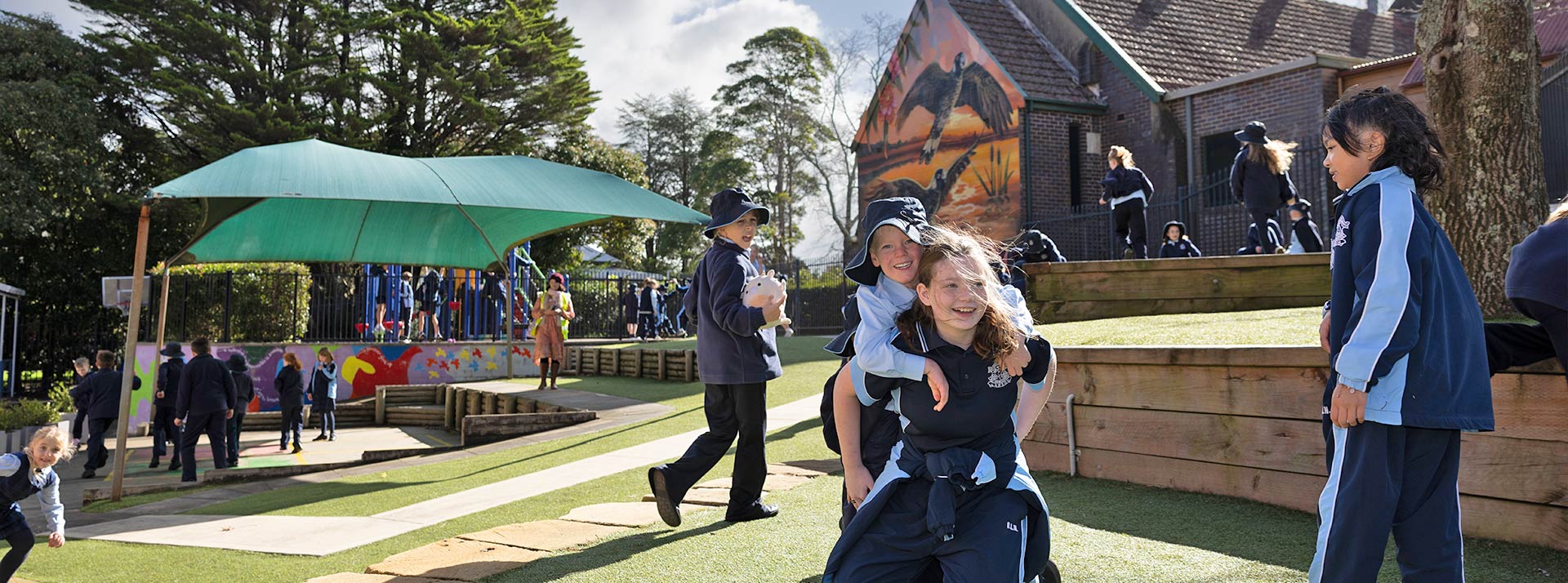 OLN Lawson student piggybacking another student around the playground