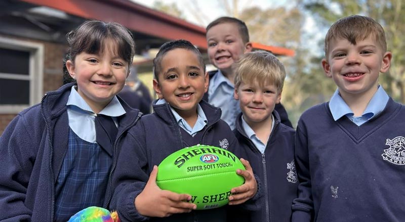 OLN Lawson students holding footballs