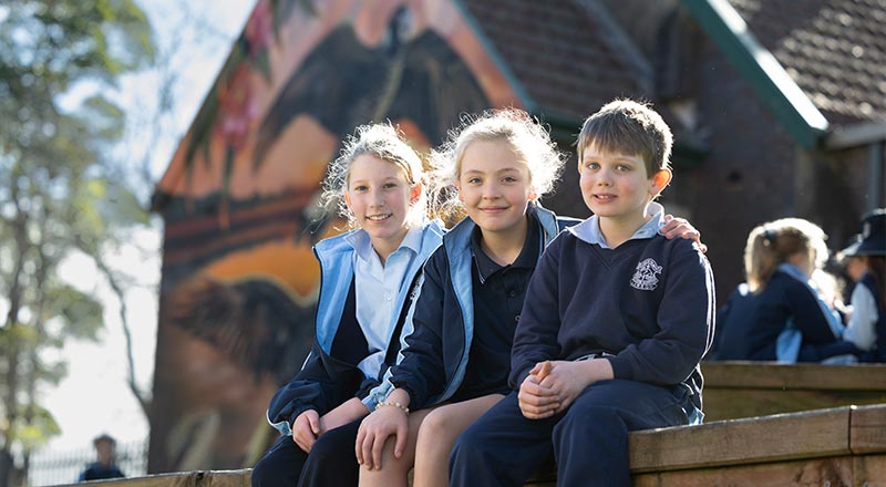 Three OLN Lawson students sitting outdoors