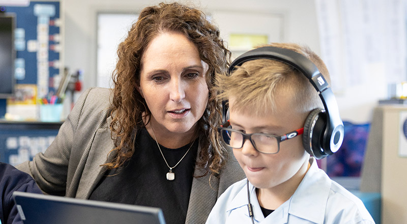 OLN Lawson teacher assisting student on laptop
