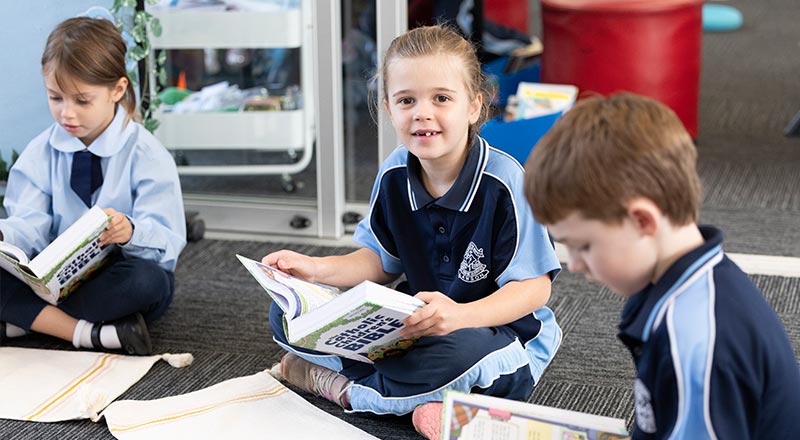 Our Lady of the Nativity Primary School Lawson student who is reading from a Children's Bible.