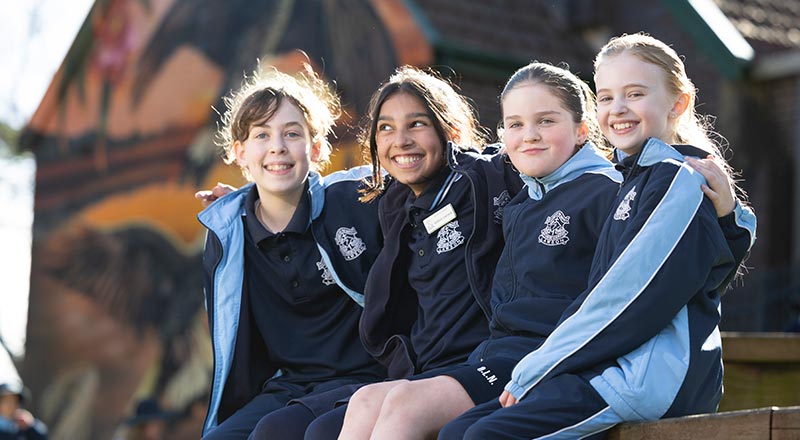 Four OLN Lawson students sitting out the front of the church