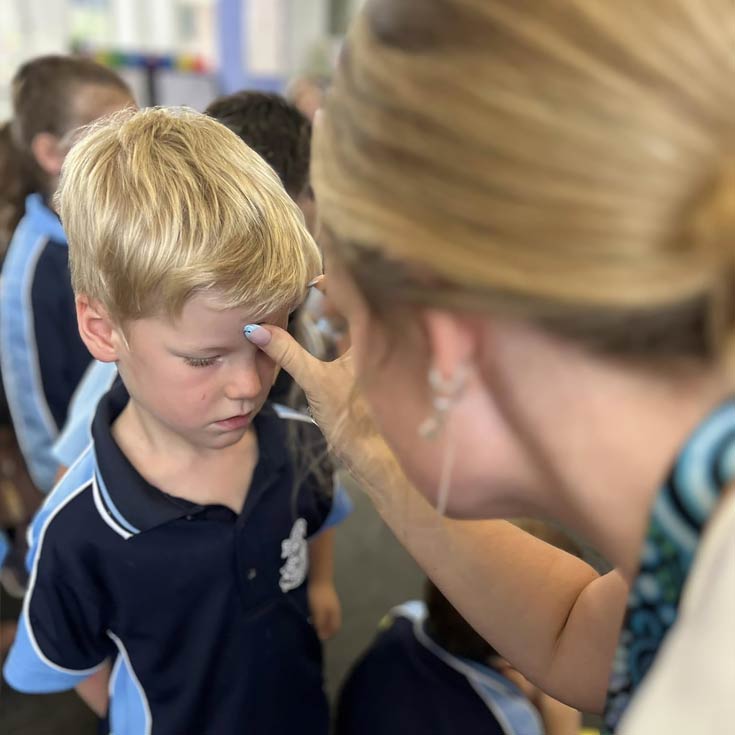 OLN Lawson Student receiving Blessing of the Ashes