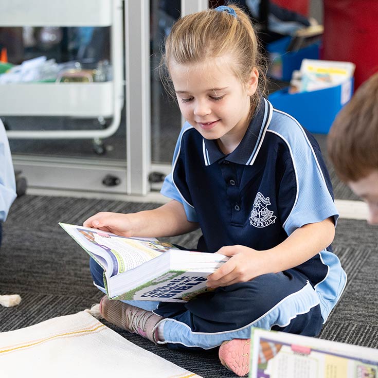 OLN Lawson student reading from Catholic Children's Bible